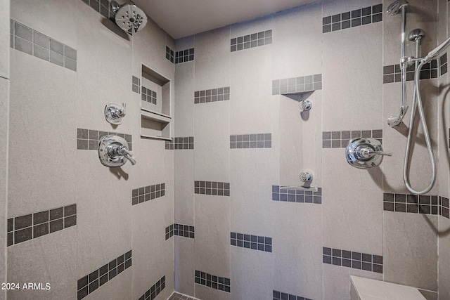 bathroom with tile walls and tiled shower