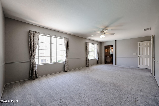 unfurnished room with ceiling fan and light carpet