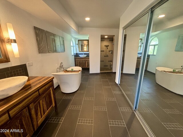 bathroom featuring vanity, separate shower and tub, and tile patterned floors