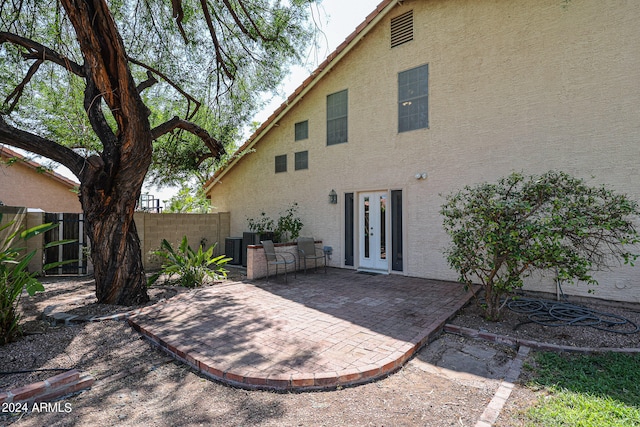 rear view of property featuring french doors and a patio area