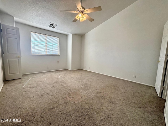 unfurnished bedroom featuring ceiling fan, lofted ceiling, light carpet, and a textured ceiling