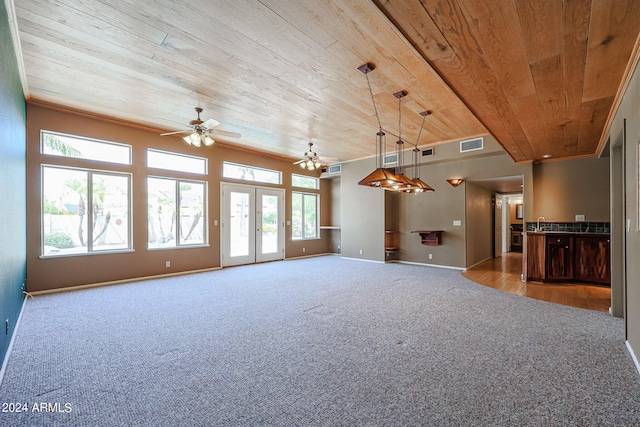 unfurnished living room with light carpet, wooden ceiling, crown molding, and ceiling fan