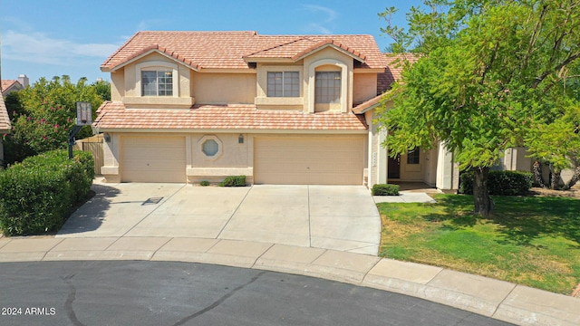 view of front of home featuring a garage and a front yard