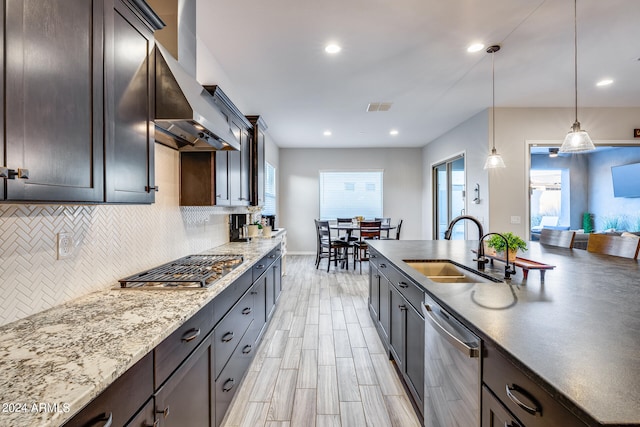 kitchen with wall chimney exhaust hood, stainless steel appliances, a healthy amount of sunlight, and sink