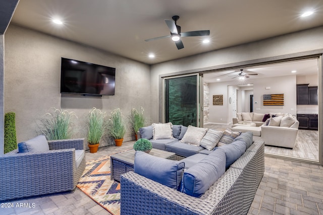 interior space featuring outdoor lounge area and ceiling fan