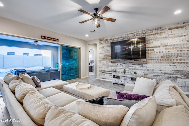 living room with light hardwood / wood-style floors and ceiling fan