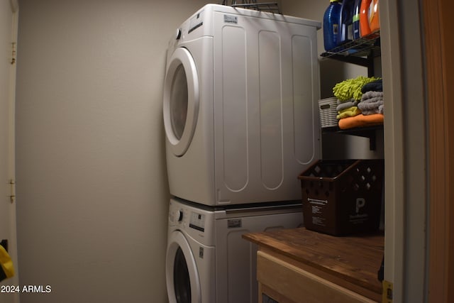 laundry room with stacked washer / dryer