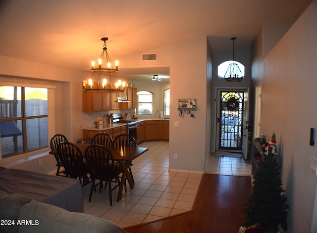 tiled dining space with an inviting chandelier