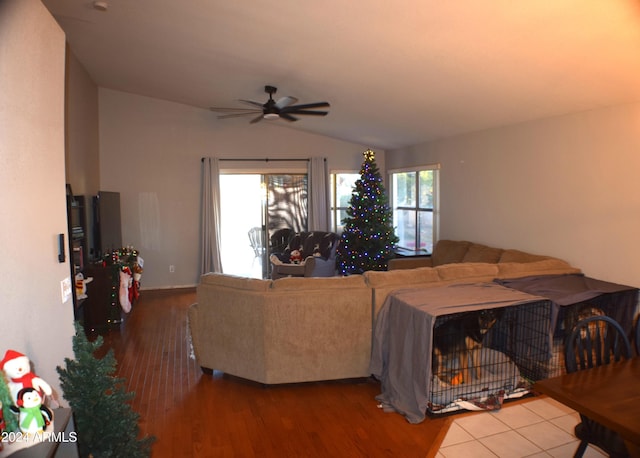 living room with vaulted ceiling, hardwood / wood-style floors, and ceiling fan