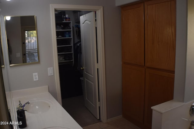 bathroom featuring vanity, a tub, and tile patterned floors