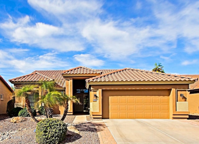 mediterranean / spanish home featuring a garage