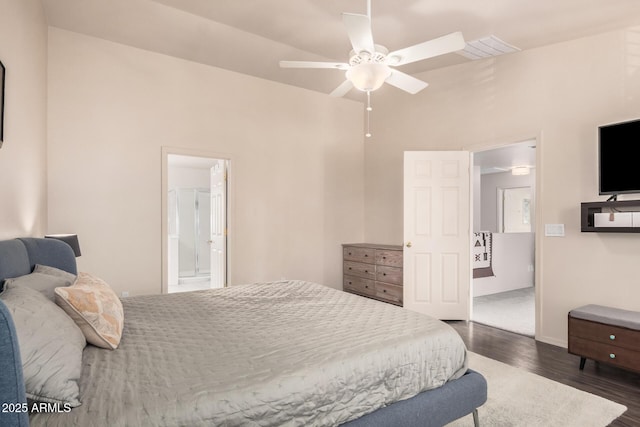bedroom featuring connected bathroom, a ceiling fan, baseboards, and dark wood finished floors