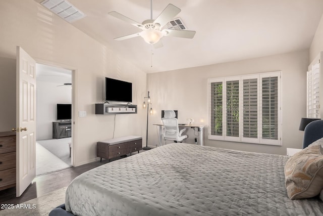 bedroom featuring a ceiling fan, visible vents, wood finished floors, and lofted ceiling