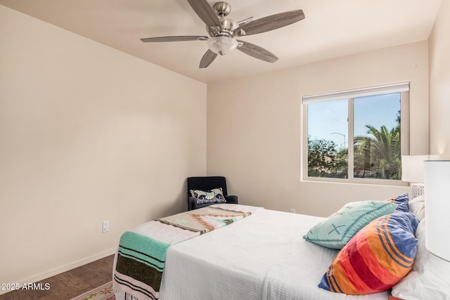 bedroom with baseboards, a ceiling fan, and wood finished floors