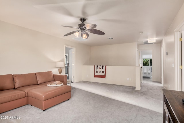 carpeted living area featuring visible vents and ceiling fan
