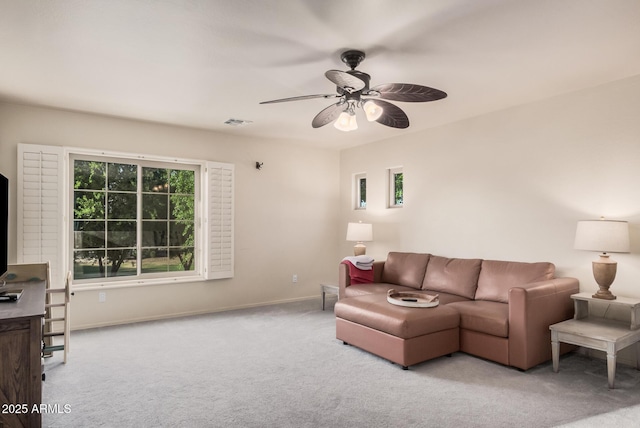 carpeted living area with baseboards, ceiling fan, and visible vents