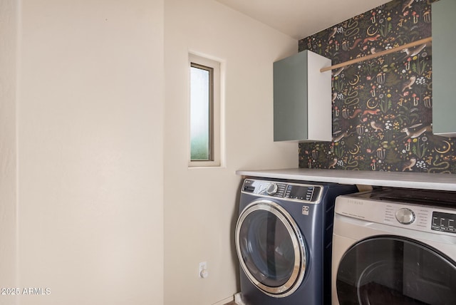 laundry room featuring separate washer and dryer and laundry area