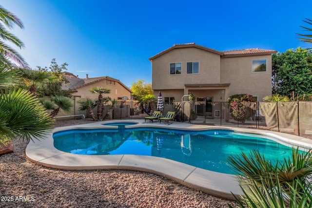 view of pool featuring an in ground hot tub, a fenced in pool, a fenced backyard, and a patio area