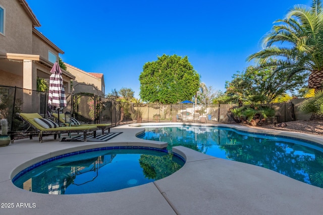 view of pool featuring a fenced backyard, a patio, and a pool with connected hot tub