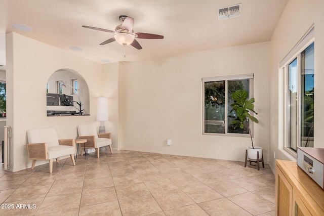 unfurnished room with visible vents, a ceiling fan, and light tile patterned floors