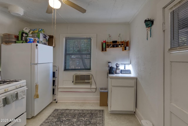 514 Brophy Ave, Bisbee, AZ 85603 - kitchen featuring crown molding, white range with gas cooktop, ceiling fan, baseboards, and a wall mounted air conditioner