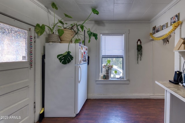 514 Brophy Ave, Bisbee, AZ 85603 - kitchen with freestanding refrigerator, dark wood-style floors, ornamental molding, light countertops, and baseboards