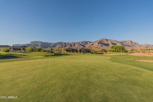 view of property's community featuring a mountain view and a yard