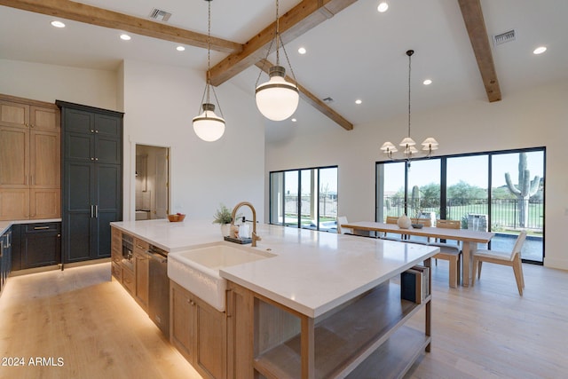 kitchen featuring sink, high vaulted ceiling, beamed ceiling, hanging light fixtures, and a large island