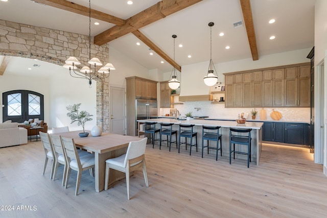 dining space with beam ceiling, french doors, high vaulted ceiling, a chandelier, and light wood-type flooring