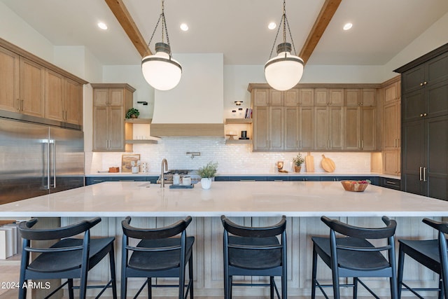 kitchen featuring beamed ceiling, backsplash, and a spacious island