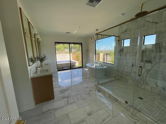 bathroom featuring vanity and independent shower and bath