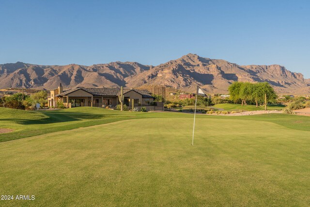 view of home's community with a mountain view and a yard