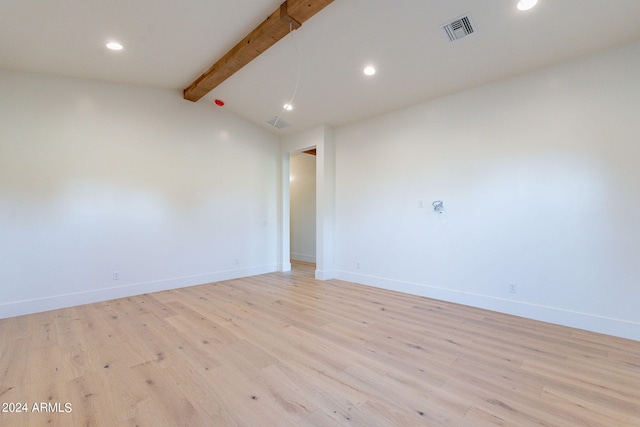 empty room with vaulted ceiling with beams and light hardwood / wood-style flooring