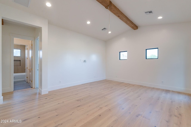 empty room with light wood-type flooring, lofted ceiling with beams, and a healthy amount of sunlight