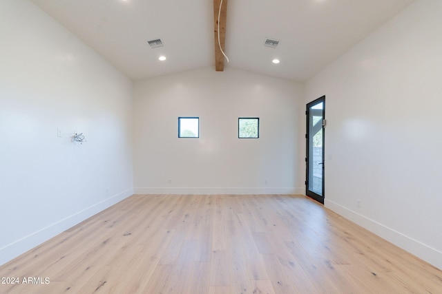 empty room featuring beam ceiling, a healthy amount of sunlight, high vaulted ceiling, and light hardwood / wood-style floors