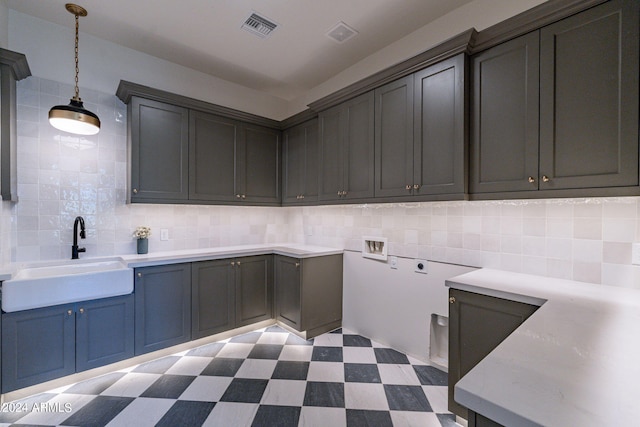 clothes washing area with electric dryer hookup, cabinets, sink, and hookup for a washing machine