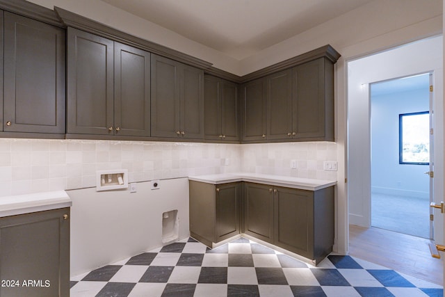 washroom featuring hookup for an electric dryer, cabinets, and washer hookup