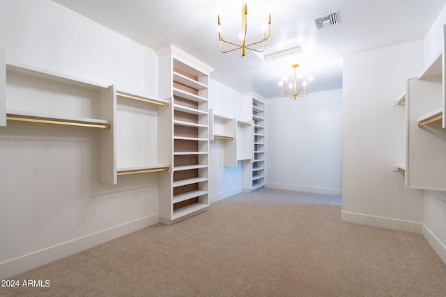 spacious closet featuring light carpet and a chandelier