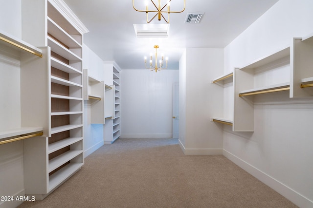 spacious closet featuring light carpet and an inviting chandelier