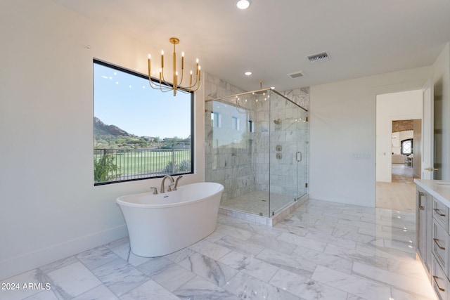 bathroom with vanity, an inviting chandelier, and independent shower and bath