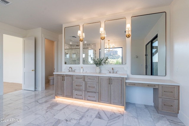 bathroom with vanity, a shower with shower door, and toilet