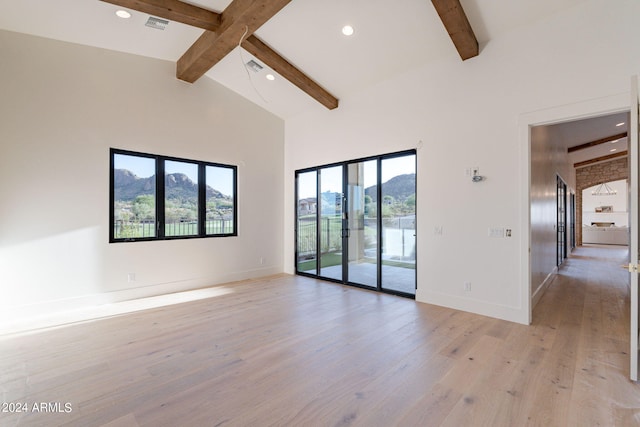 unfurnished room featuring beamed ceiling, light wood-type flooring, and high vaulted ceiling