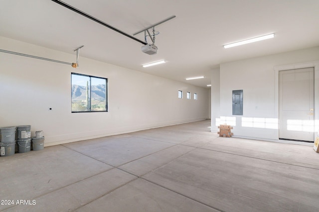 garage with electric panel and a garage door opener