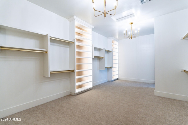 walk in closet with light carpet and a chandelier