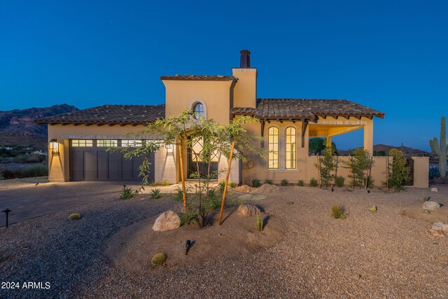 mediterranean / spanish home with a mountain view and a garage