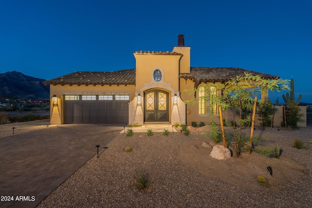 mediterranean / spanish home with a mountain view and a garage