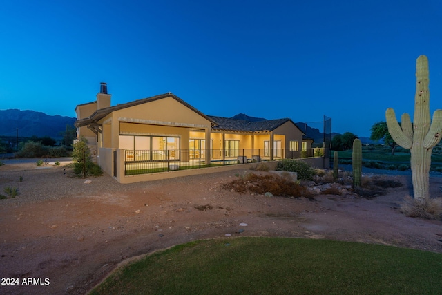 back of property featuring a mountain view