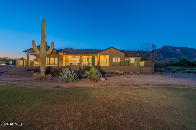 view of front of home featuring a lawn and a mountain view