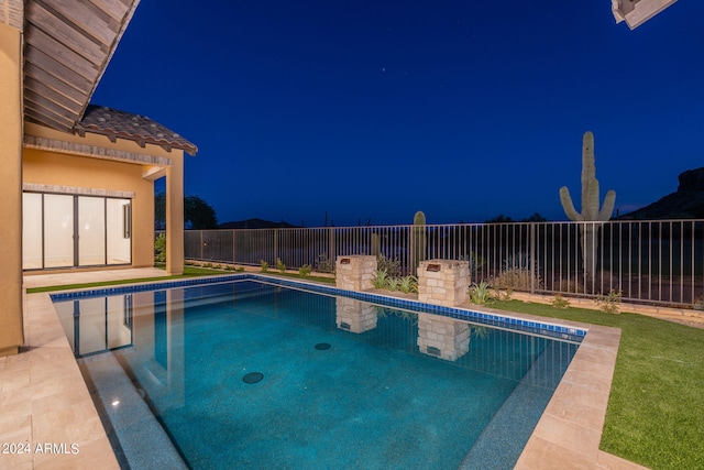 view of pool at night