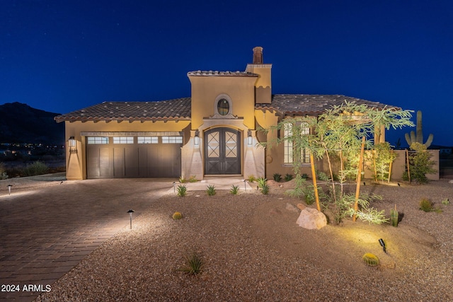 mediterranean / spanish-style house with a garage